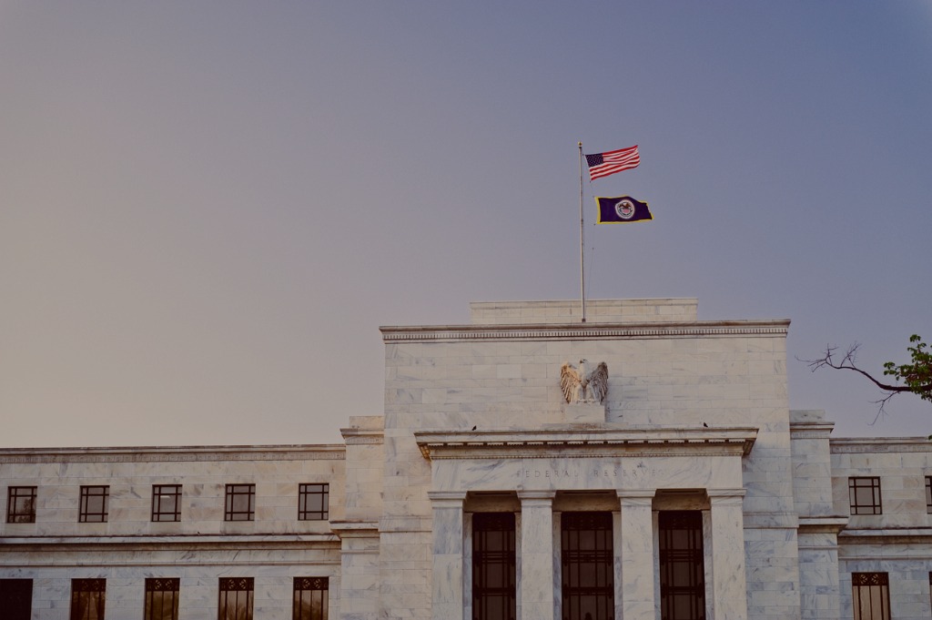 federal-reserve-building-at-sunset-with-us-flag-on-top-picture-id155377314